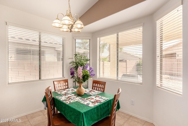 tiled dining area with a chandelier and lofted ceiling