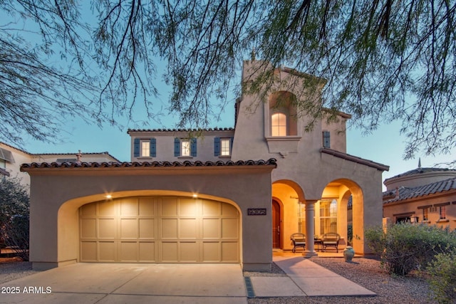 9305 E Canyon View Rd, Scottsdale, AZ 85255 - mediterranean / spanish house featuring a tiled roof, stucco siding, an attached garage, and concrete driveway
