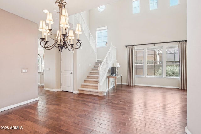 9305 E Canyon View Rd, Scottsdale, AZ 85255 - interior space featuring wood finished floors, baseboards, a high ceiling, stairs, and a chandelier
