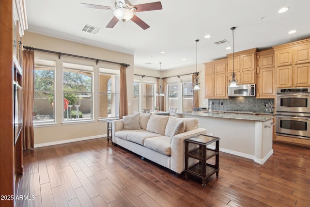 9305 E Canyon View Rd, Scottsdale, AZ 85255 - living room with dark wood-style floors, visible vents, baseboards, and ceiling fan