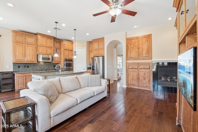 9305 E Canyon View Rd, Scottsdale, AZ 85255 - living area featuring visible vents, recessed lighting, arched walkways, a ceiling fan, and dark wood-style flooring