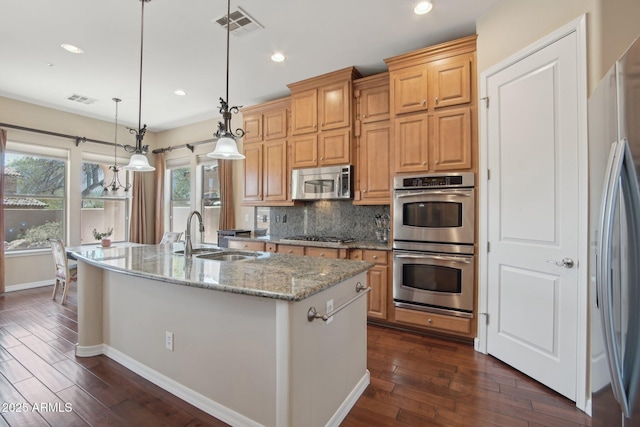 9305 E Canyon View Rd, Scottsdale, AZ 85255 - kitchen featuring visible vents, a sink, backsplash, dark wood-style floors, and appliances with stainless steel finishes
