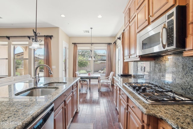 9305 E Canyon View Rd, Scottsdale, AZ 85255 - kitchen featuring backsplash, dark wood finished floors, light stone counters, appliances with stainless steel finishes, and a sink