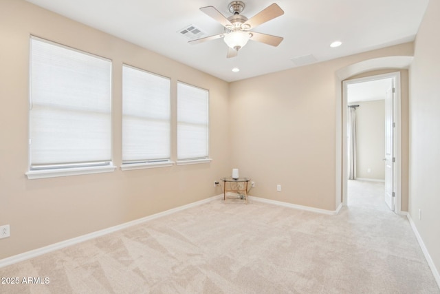 9305 E Canyon View Rd, Scottsdale, AZ 85255 - unfurnished room with visible vents, baseboards, carpet, arched walkways, and a ceiling fan