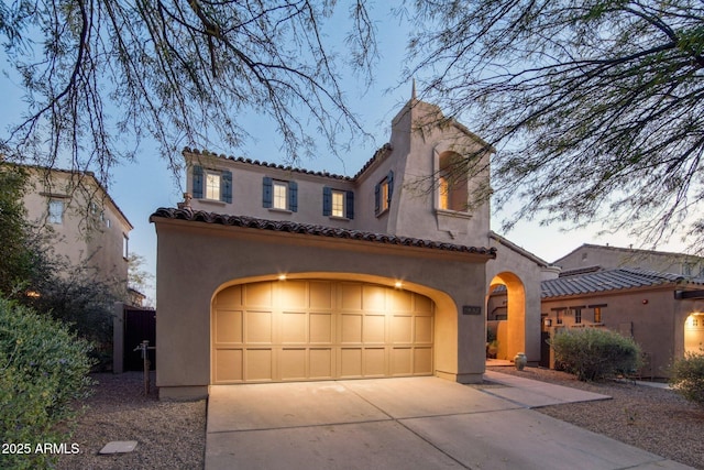 9305 E Canyon View Rd, Scottsdale, AZ 85255 - mediterranean / spanish house featuring a tile roof, an attached garage, driveway, and stucco siding