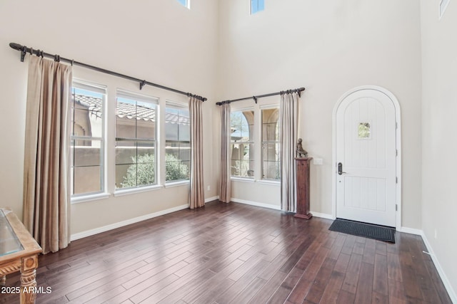 9305 E Canyon View Rd, Scottsdale, AZ 85255 - foyer entrance featuring visible vents, baseboards, dark wood finished floors, and a towering ceiling