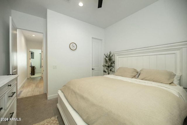 bedroom featuring a ceiling fan, recessed lighting, light colored carpet, and baseboards