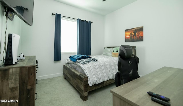 bedroom featuring light colored carpet and baseboards