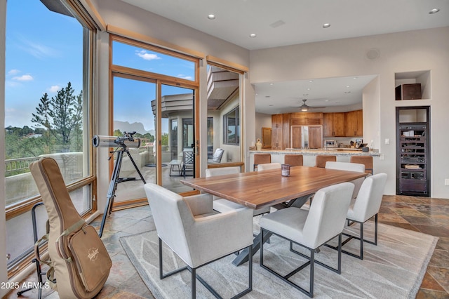dining space with a ceiling fan, stone tile flooring, and recessed lighting