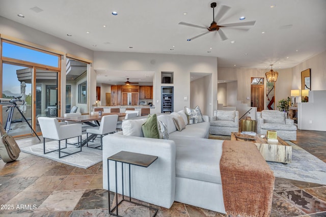 living room with ceiling fan, recessed lighting, stone tile floors, and stairs