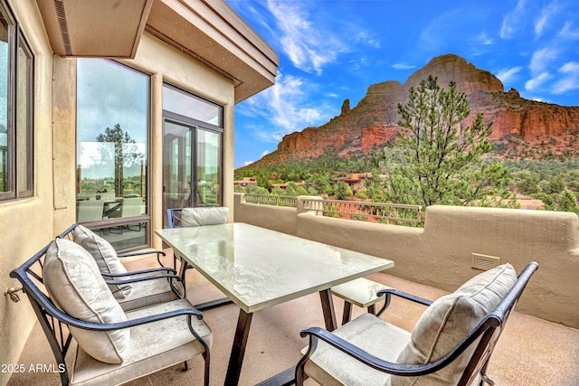 exterior space featuring outdoor dining space and a mountain view