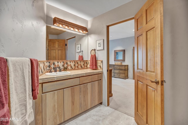 bathroom with tasteful backsplash and vanity