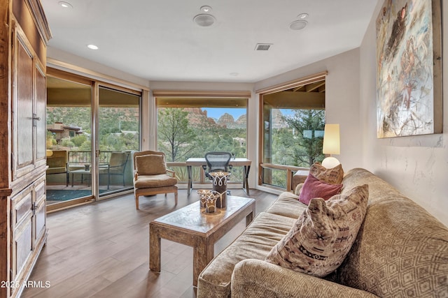 living area featuring visible vents, recessed lighting, and wood finished floors