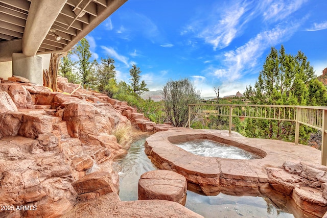 exterior space featuring an in ground hot tub