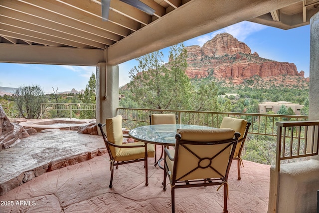 view of patio with outdoor dining space and a mountain view