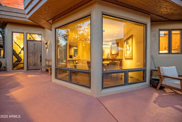 exterior space featuring a patio and stucco siding