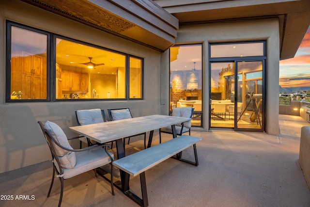 patio terrace at dusk featuring outdoor dining area