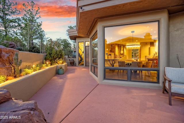 view of patio terrace at dusk
