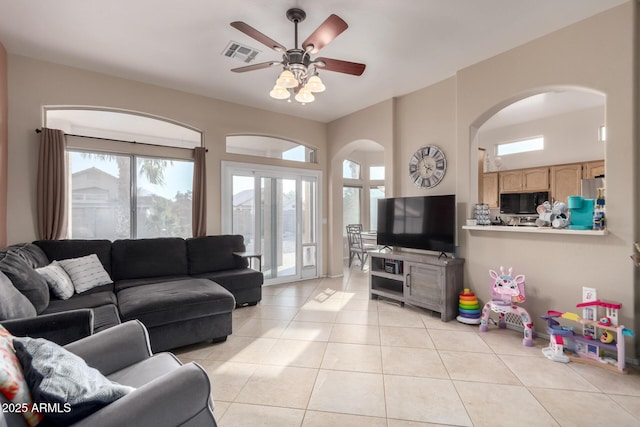 living room with ceiling fan and light tile patterned floors