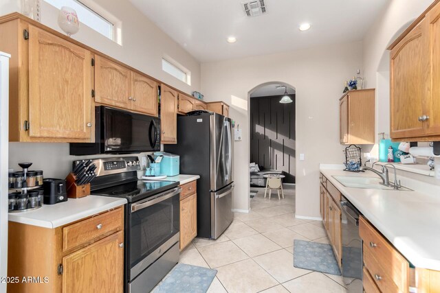 kitchen featuring appliances with stainless steel finishes, sink, and light tile patterned floors