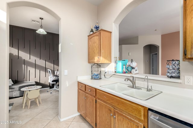 kitchen with pendant lighting, sink, stainless steel dishwasher, and light tile patterned flooring