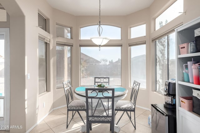 dining space featuring light tile patterned floors and a healthy amount of sunlight