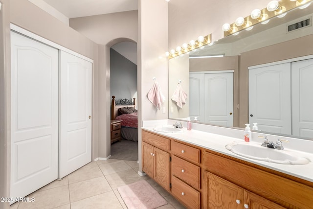 bathroom with tile patterned floors and vanity