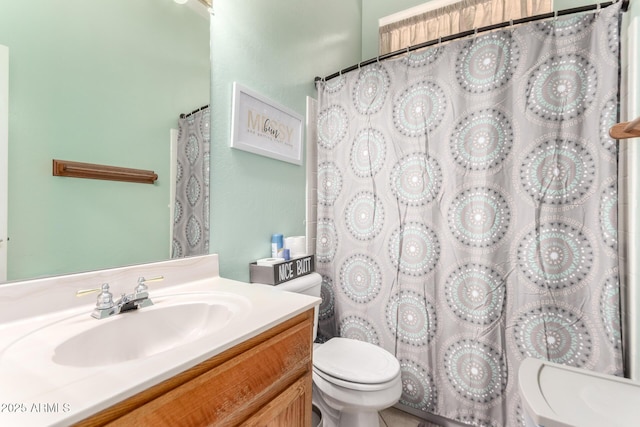 bathroom featuring walk in shower, vanity, and toilet