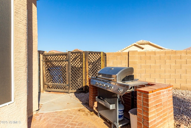 view of patio featuring a grill