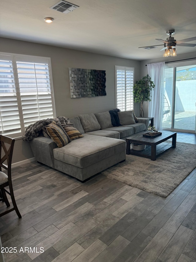 living room featuring hardwood / wood-style floors and ceiling fan