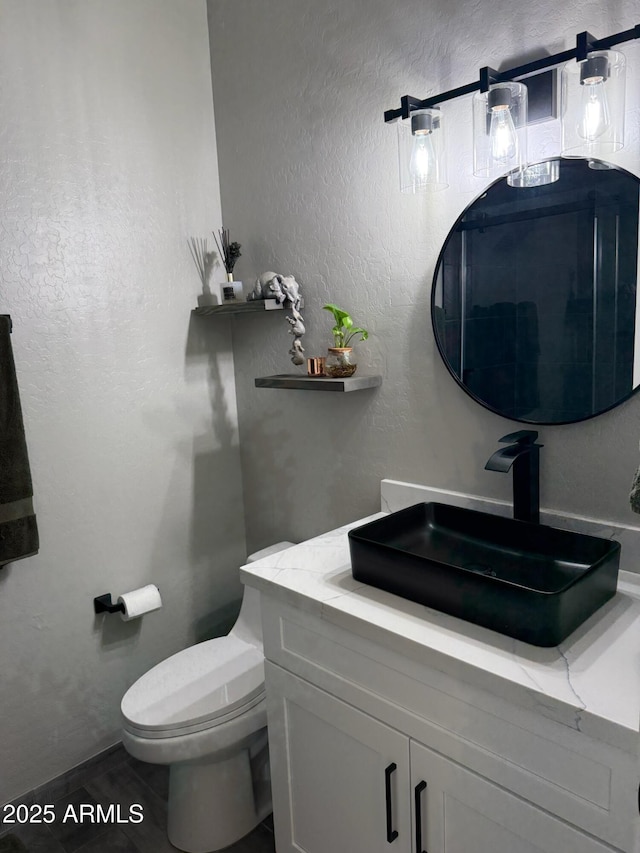 bathroom featuring vanity and toilet