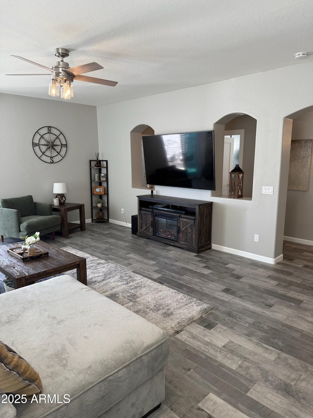 living room featuring dark hardwood / wood-style floors and ceiling fan