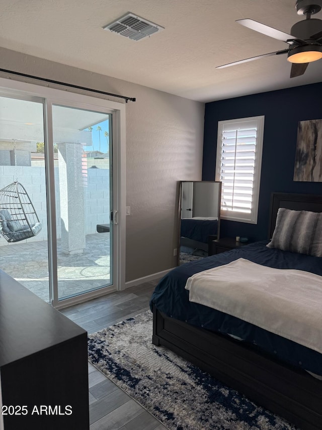 bedroom featuring access to exterior, hardwood / wood-style flooring, and ceiling fan