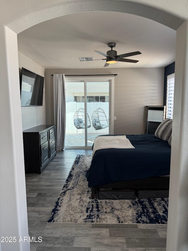 bedroom with hardwood / wood-style floors, access to exterior, and ceiling fan