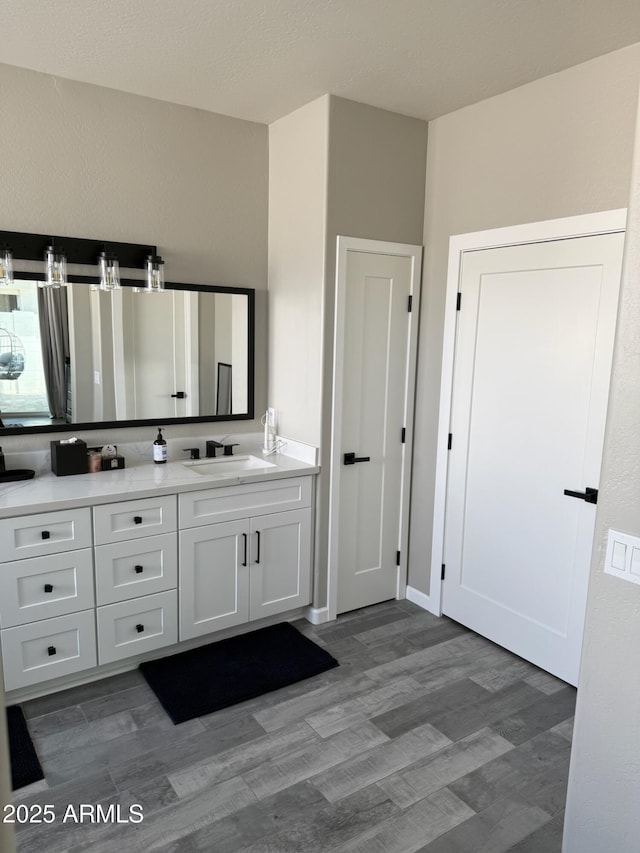 bathroom featuring vanity and wood-type flooring