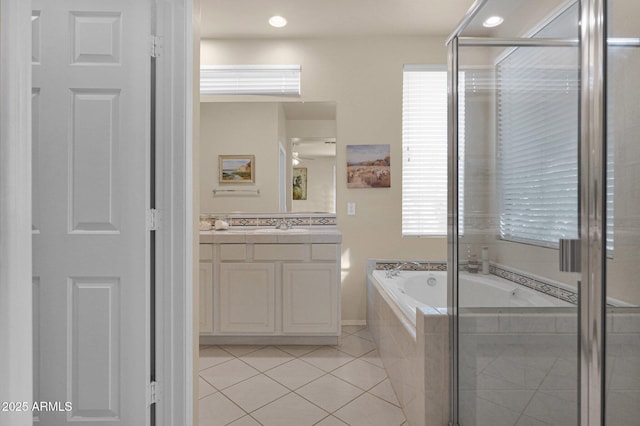 bathroom with tile patterned floors, vanity, separate shower and tub, and a wealth of natural light