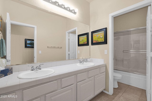 full bathroom featuring tile patterned flooring, vanity, toilet, and enclosed tub / shower combo