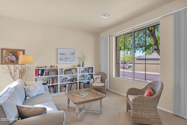 sitting room featuring light carpet