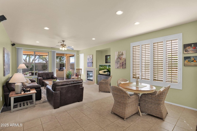 tiled living room featuring ceiling fan