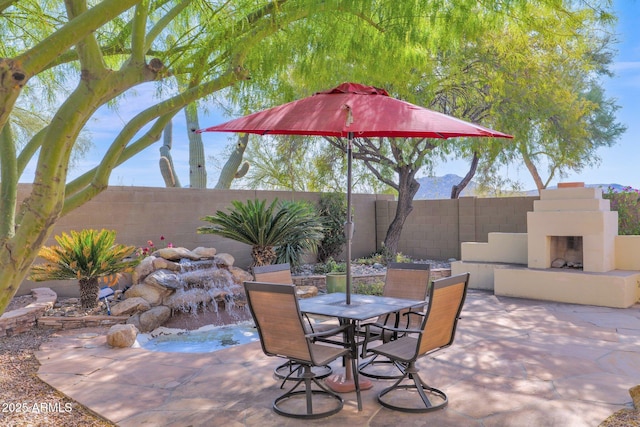 view of patio / terrace with an outdoor fireplace