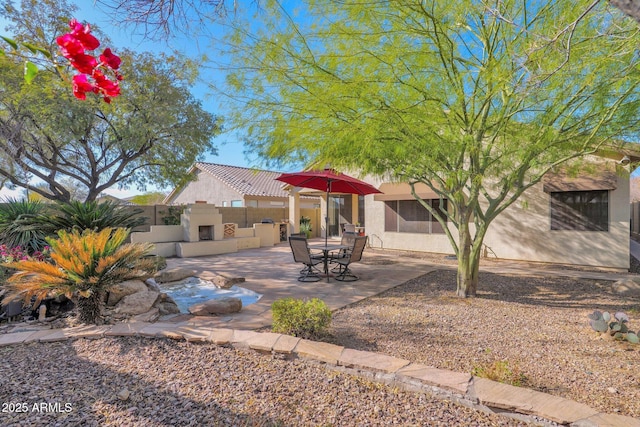 view of patio featuring exterior fireplace