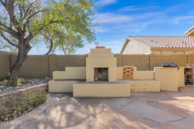 view of patio / terrace with exterior fireplace