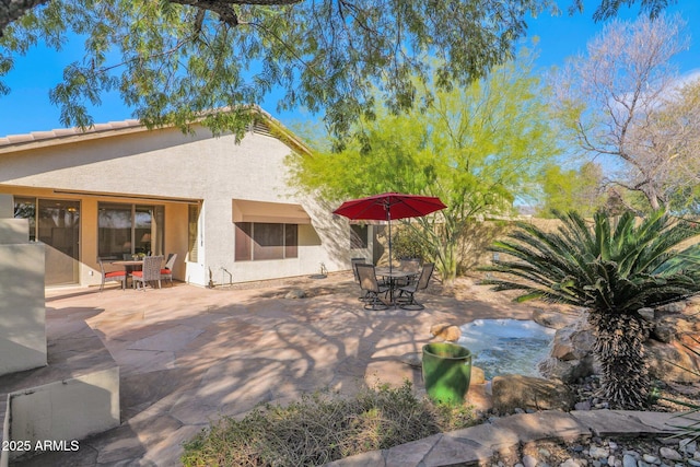 rear view of house featuring a patio