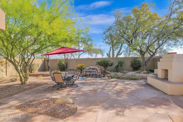 view of patio with an outdoor fireplace