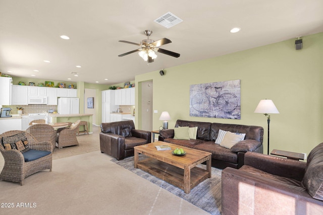 carpeted living room featuring ceiling fan