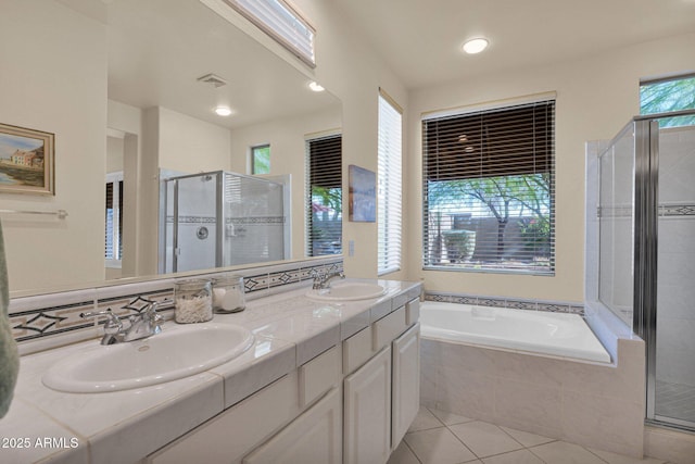 bathroom with tile patterned flooring, vanity, plenty of natural light, and plus walk in shower