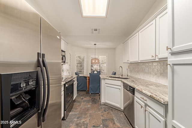 19812 N 90th Dr, Peoria, AZ 85382 - kitchen with a sink, stone finish flooring, visible vents, white cabinetry, and appliances with stainless steel finishes