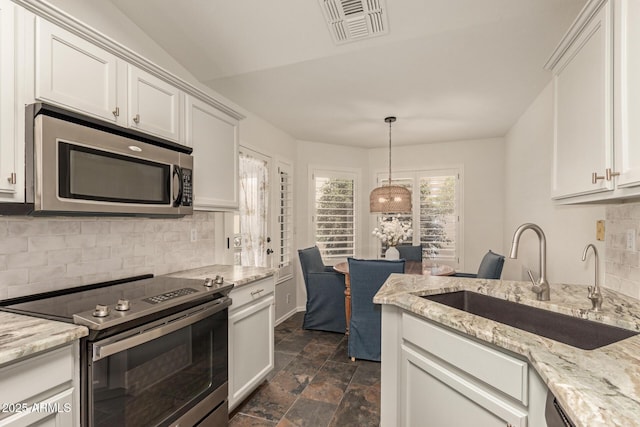19812 N 90th Dr, Peoria, AZ 85382 - kitchen with appliances with stainless steel finishes, white cabinets, backsplash, a sink, and visible vents