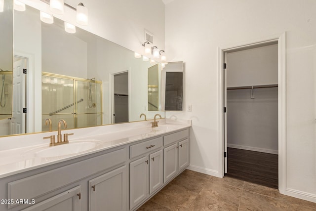 19812 N 90th Dr, Peoria, AZ 85382 - full bathroom featuring baseboards, a sink, a shower stall, and a spacious closet