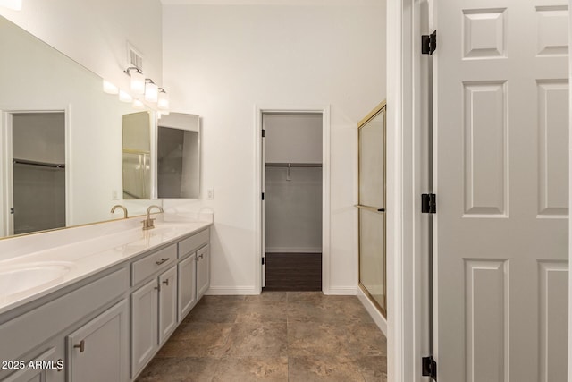 19812 N 90th Dr, Peoria, AZ 85382 - full bathroom with a sink, a shower with shower door, double vanity, and a walk in closet